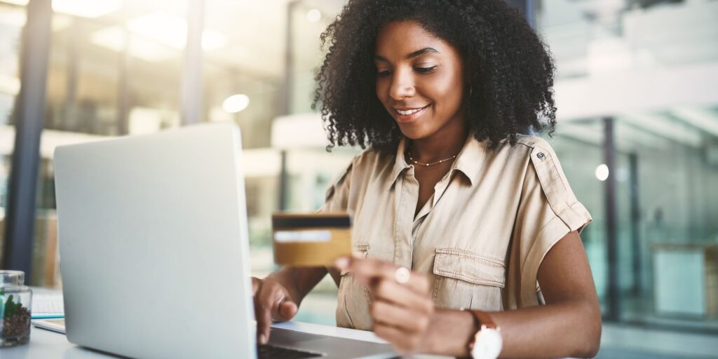 woman on a computer with a credit card