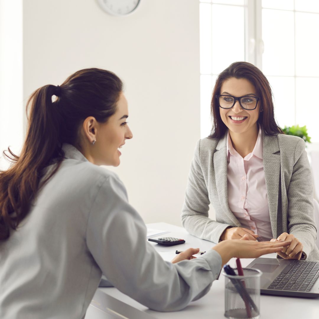 Young woman speaking with banking professional