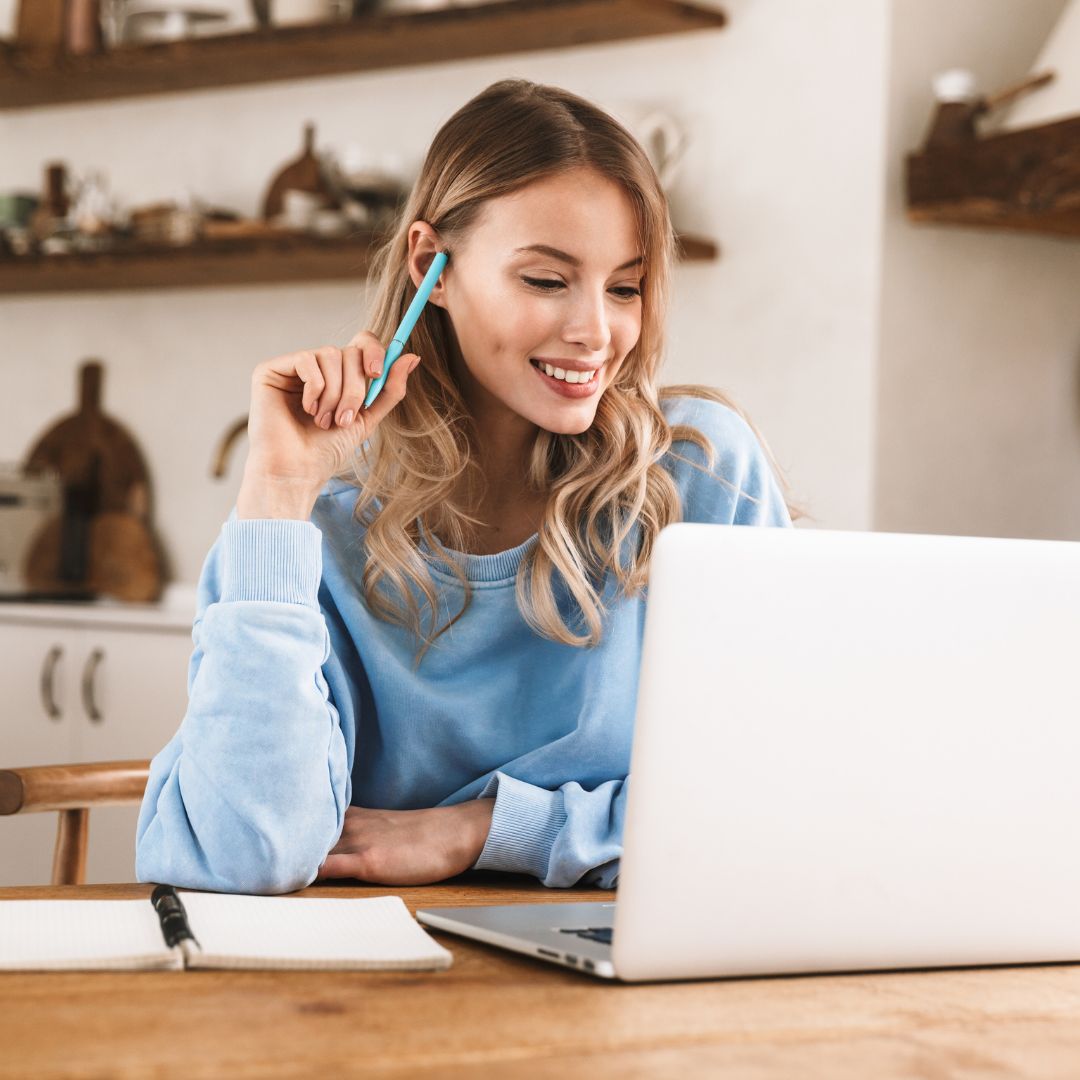 woman on laptop smiling
