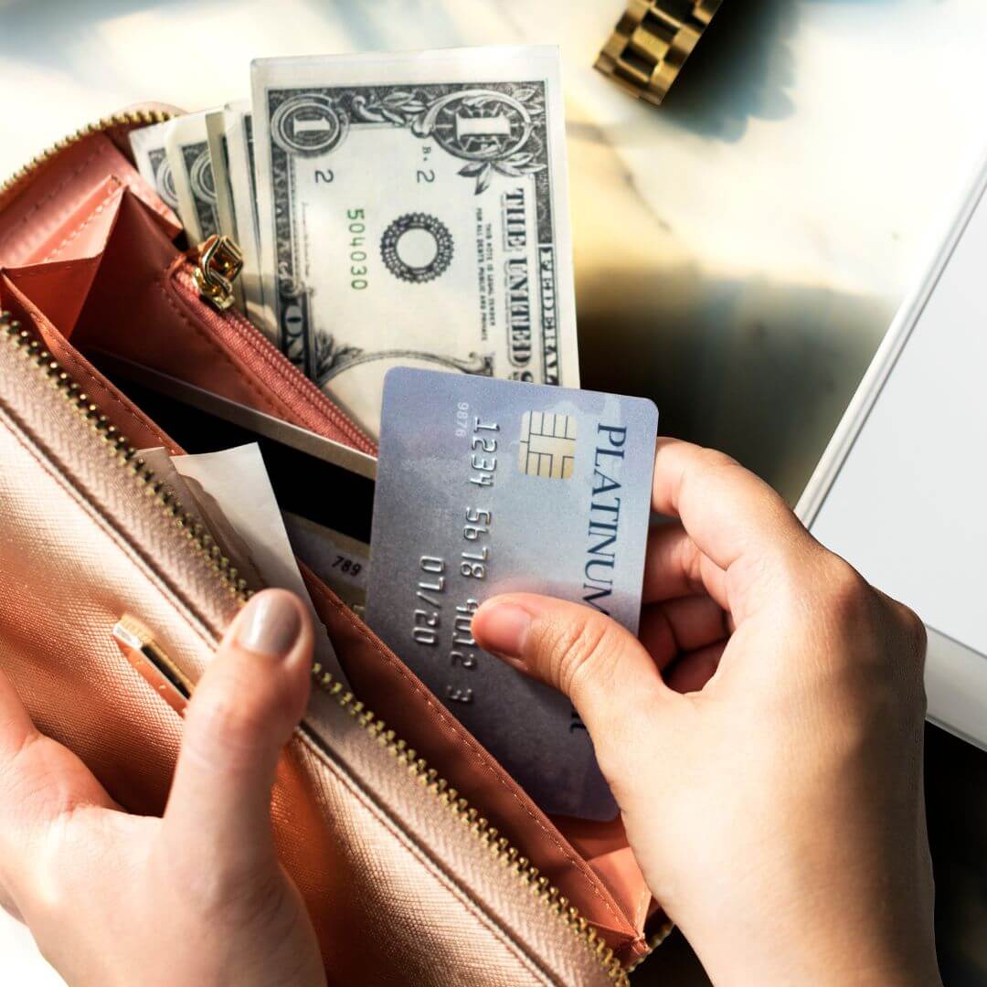 person removing credit card from wallet