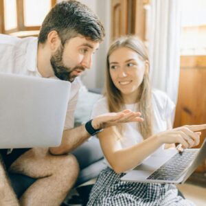 Couple looking at laptops